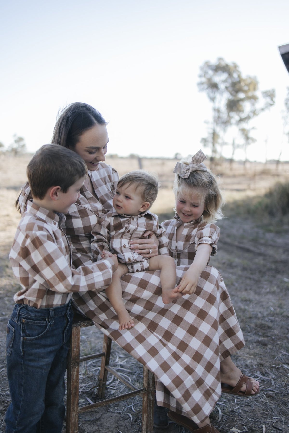 Mum, baby and kids in matching brown gingham, The Tully Collection