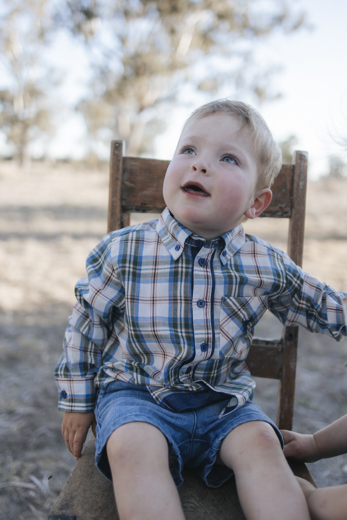 Baby in blue plaid shirt style bodysuit