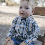 Toddler in blue plaid shirt