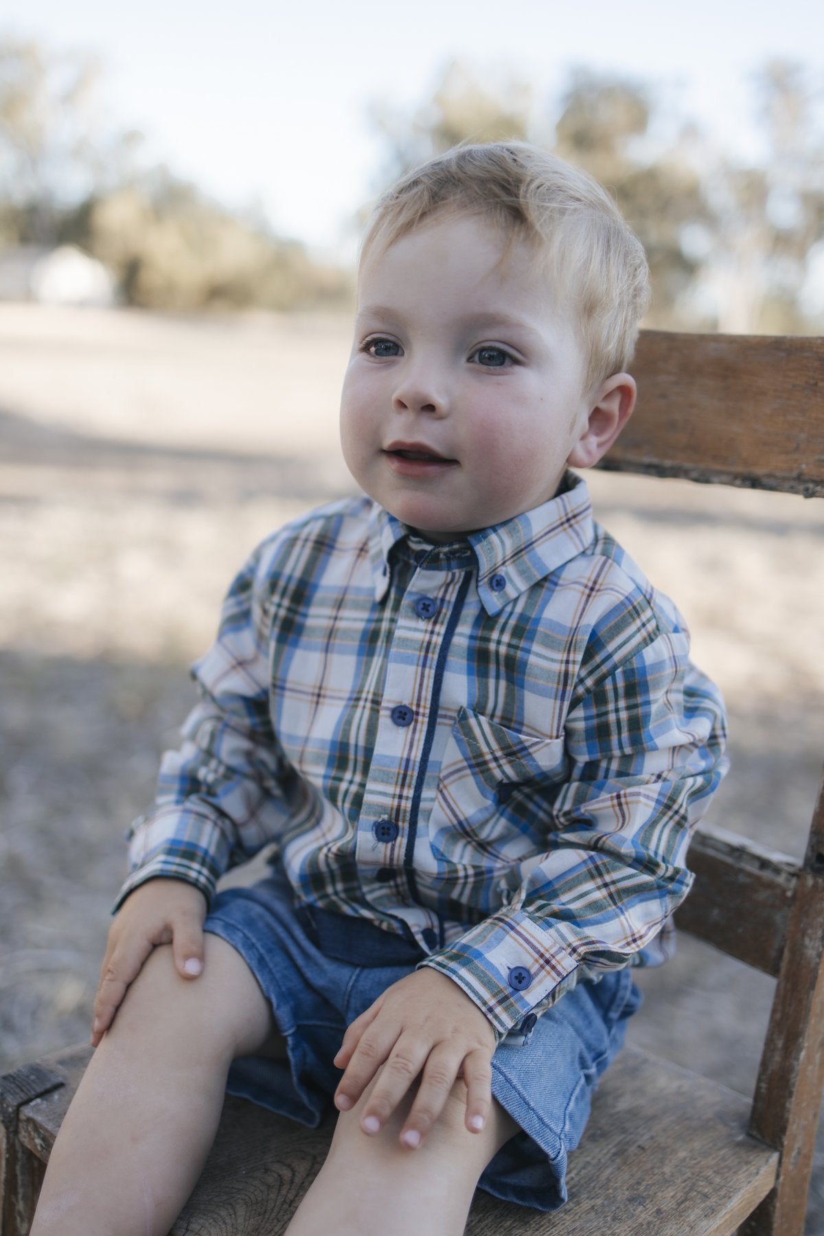 Toddler in blue plaid shirt