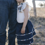 Girl in denim tiered skirt and white top