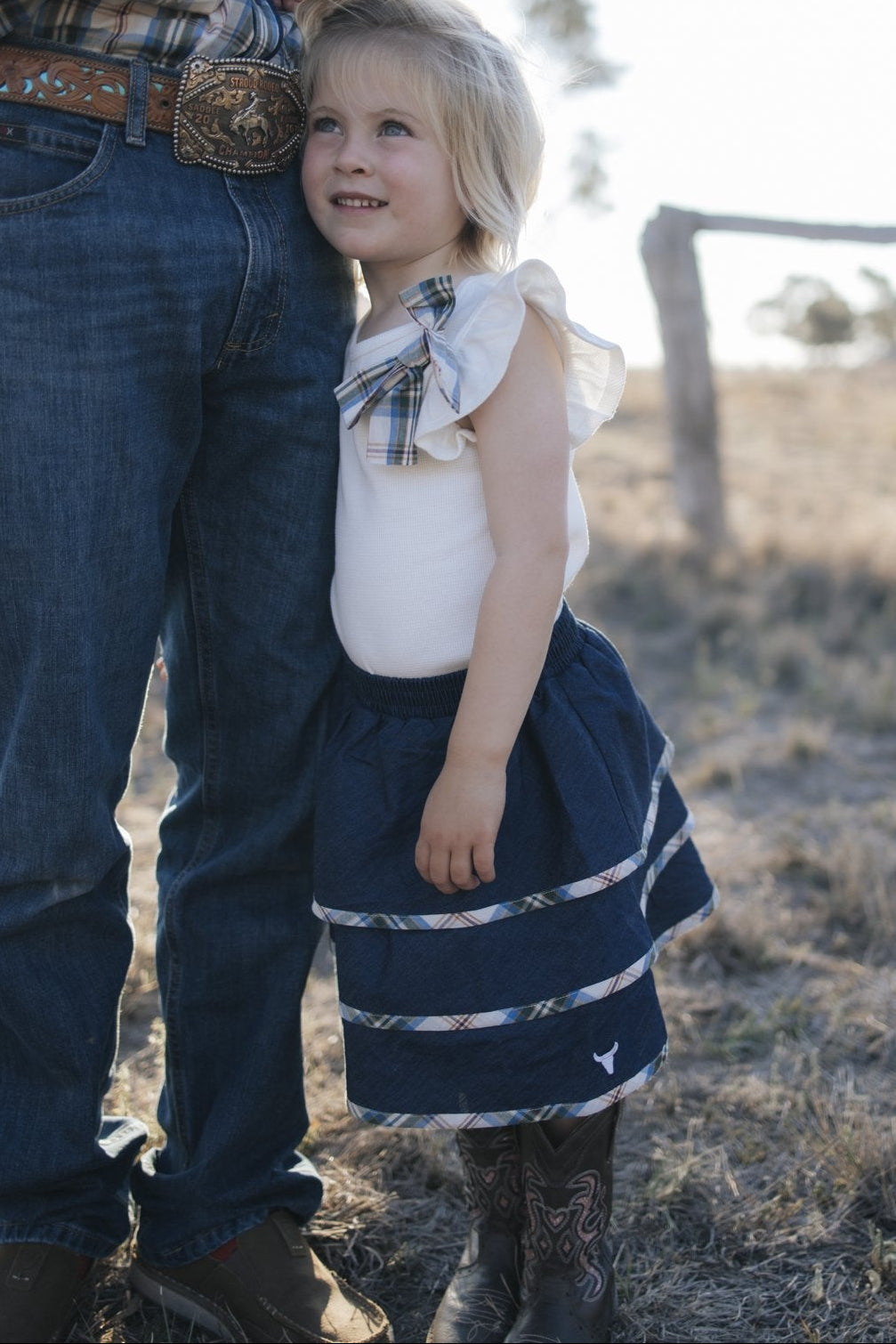 Girl in denim tiered skirt and white top