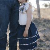 Girl in denim tiered skirt and white top