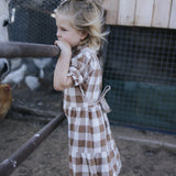 Girls brown gingham dress side view with tie