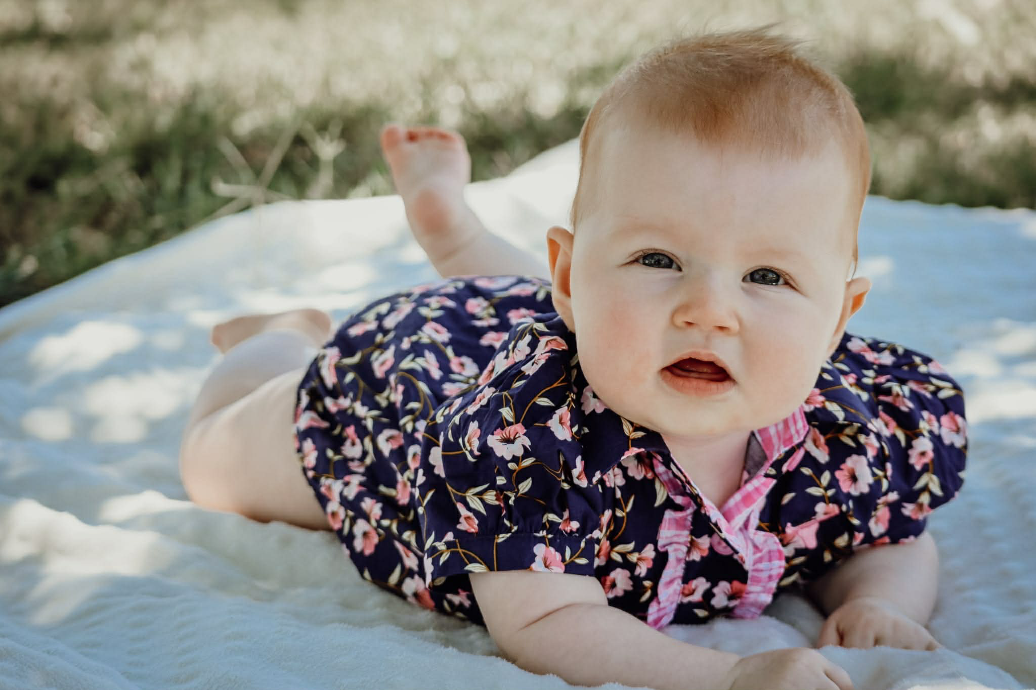 Harlo navy floral short sleeve romper flatlay showing full navy floral print design