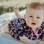 Harlo navy floral short sleeve romper flatlay showing full navy floral print design