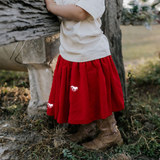 Rena deep red textured tutu waistband detail showing elastic waist and quality construction
