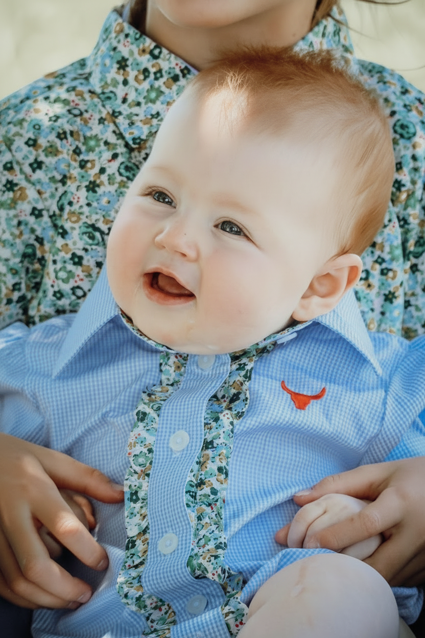 Dasha soft baby blue gingham short sleeve romper back view showing snap closure and soft blue gingham