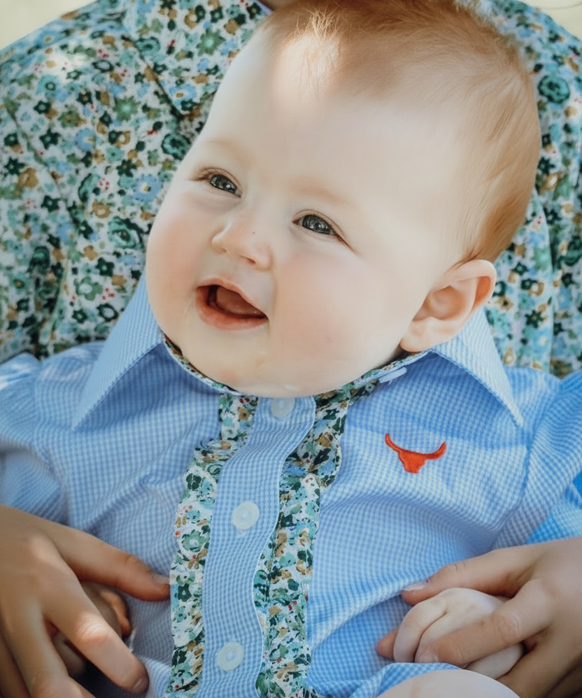 Dasha soft baby blue gingham short sleeve romper back view showing snap closure and soft blue gingham