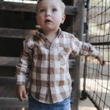 Toddler in brown gingham shirt
