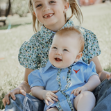 Dasha soft baby blue gingham short sleeve romper flatlay showing full soft blue gingham design
