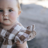 Gingham romper frill sleeve close-up
