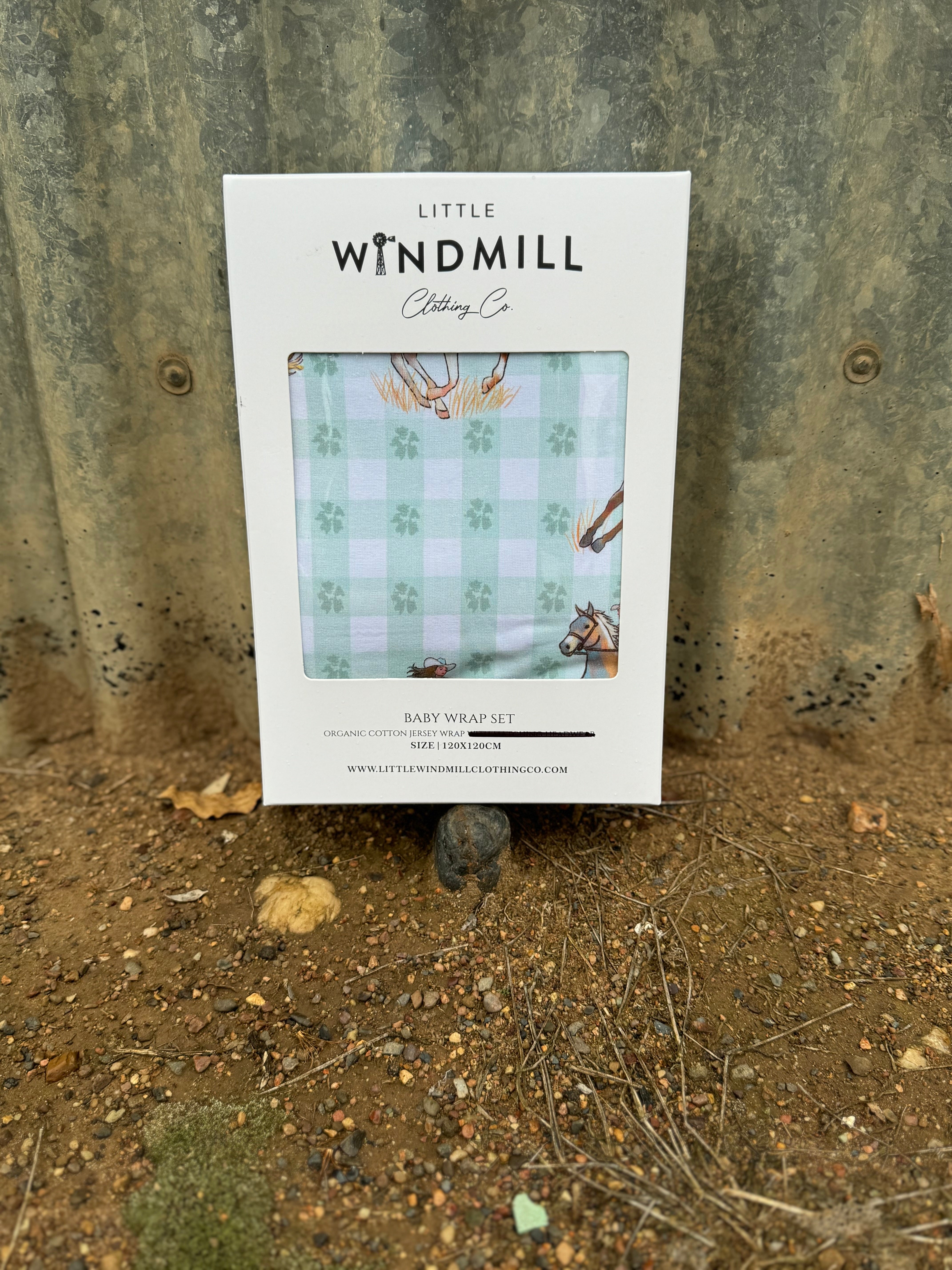 Teal cowgirl organic cotton swaddle draped showing large generous size for swaddling and wrapping