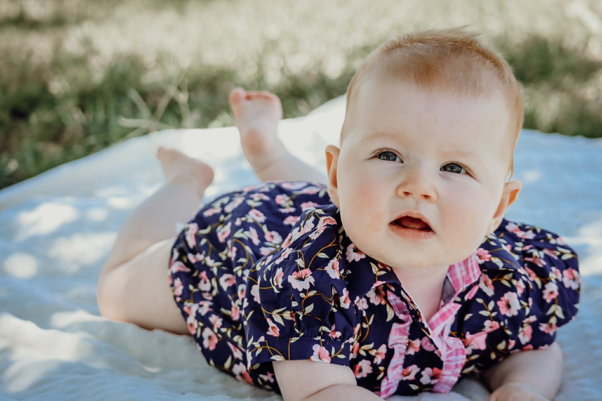 Harlo navy floral short sleeve romper back view showing snap closure and navy floral print