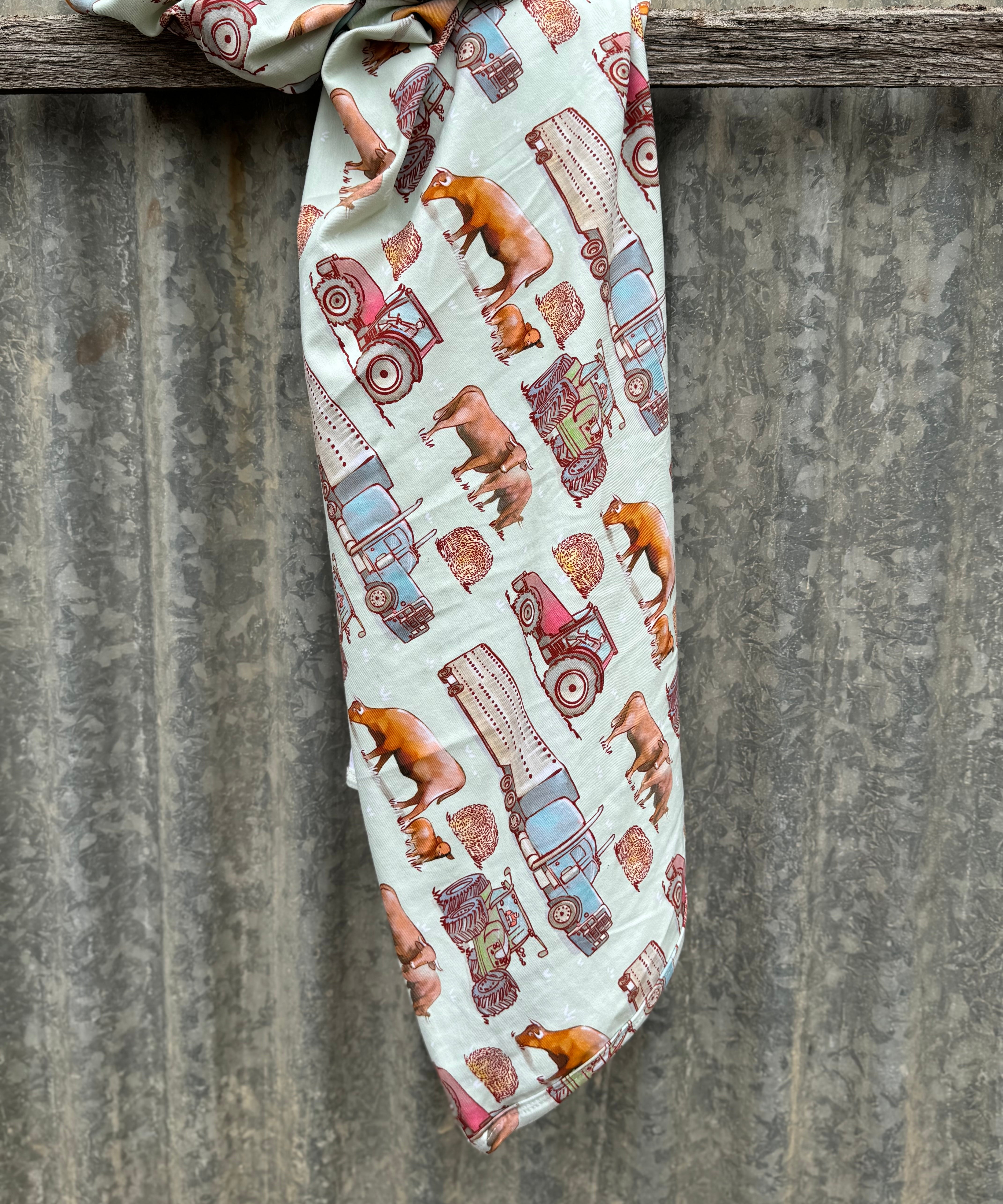 Ranch life jersey organic cotton swaddle showing classic ranch-themed print on 100% organic cotton