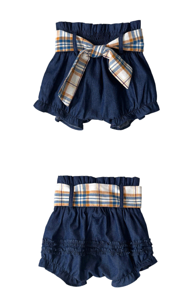 Navy blue baby bloomers with plaid ribbon on a gray background