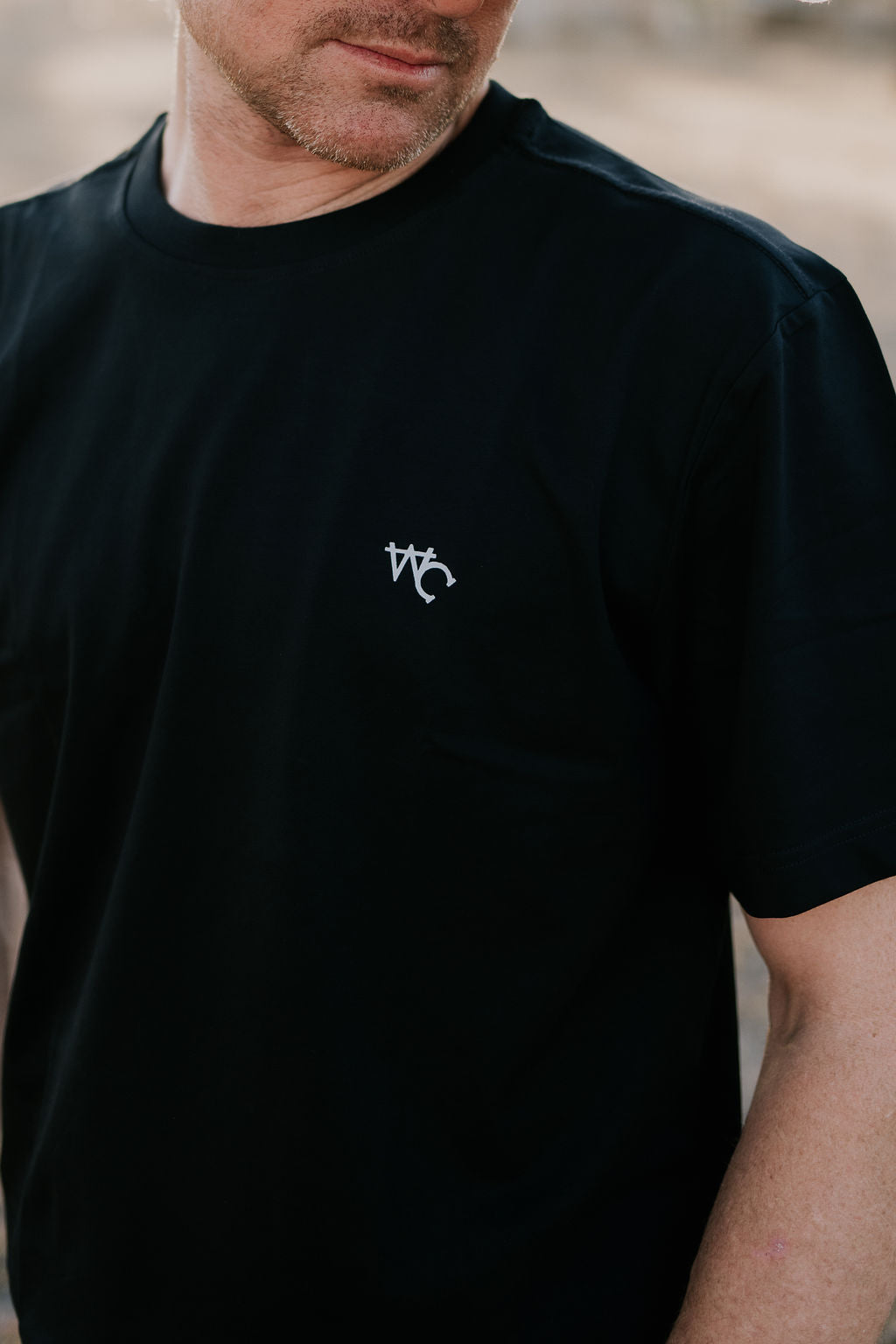 WC Printed Men's Tee Midnight Black flat lay on light surface