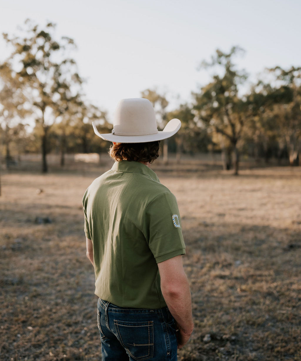 Olive Guy green contrast men's polo on model showing country lifestyle fit