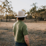 Olive Guy green contrast men's polo on model showing country lifestyle fit