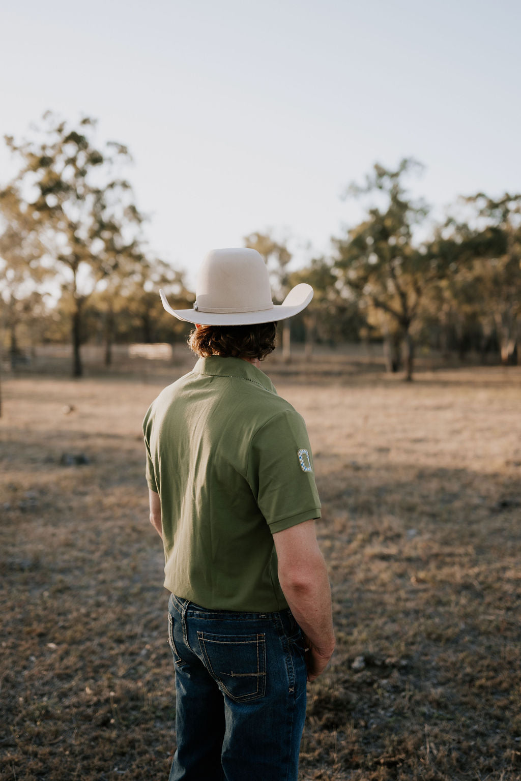 Olive Guy green contrast men's polo on model showing country lifestyle fit