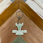 Little Windmill Clothing Co key chain showing branded accessory with windmill logo detail