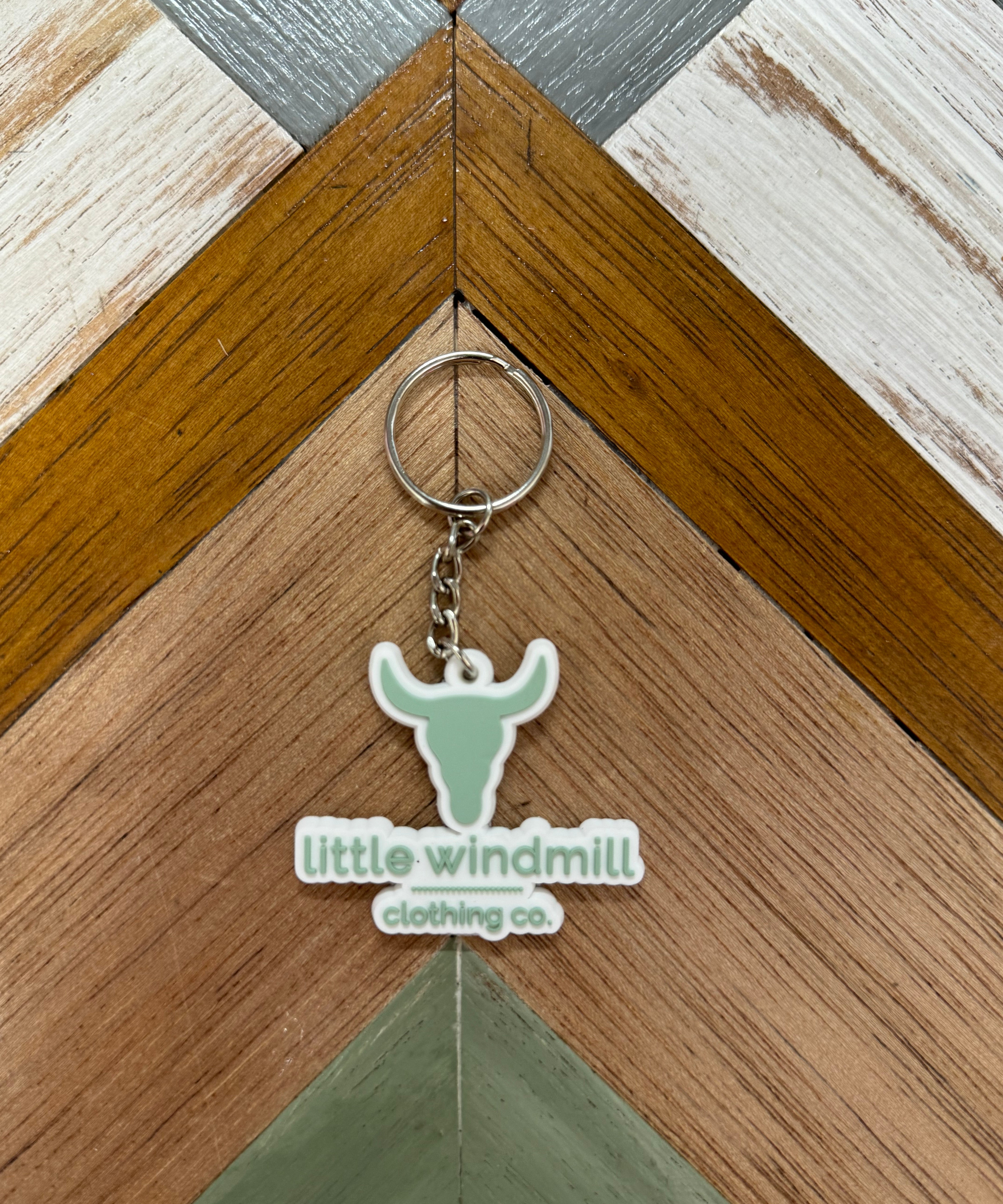 Little Windmill Clothing Co key chain close-up showing quality metal detail and LWCC branding