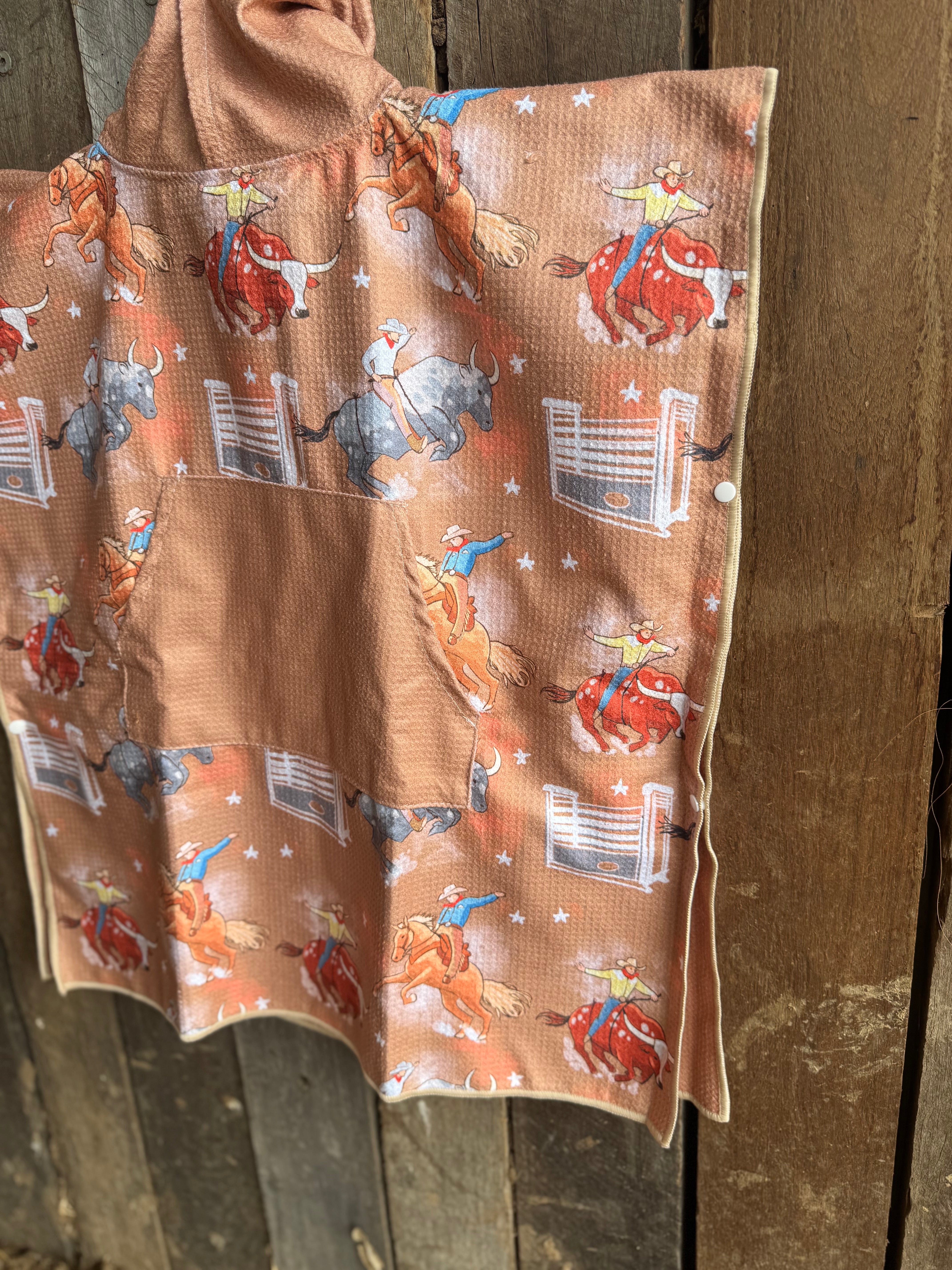 Bull Rider brown kids waffle towel in use showing kids towel with bull rider print