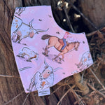 Waterproof pink long horn bib front view showing adorable pink longhorn cattle print on wipeable waterproof fabric