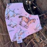 Waterproof pink long horn bib front view showing adorable pink longhorn cattle print on wipeable waterproof fabric
