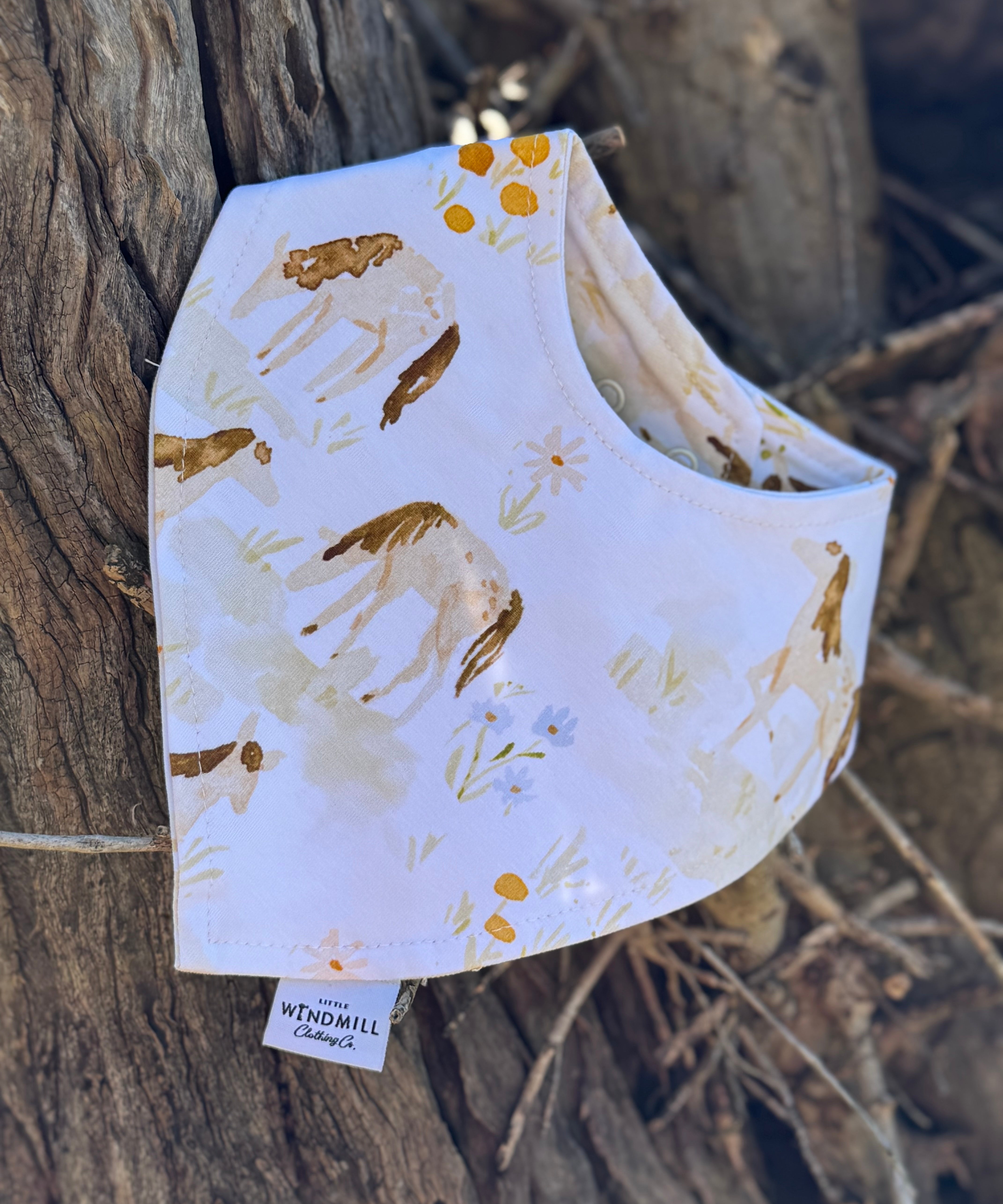 Waterproof horse field bib front view showing beautiful horse field scene print on wipeable waterproof fabric