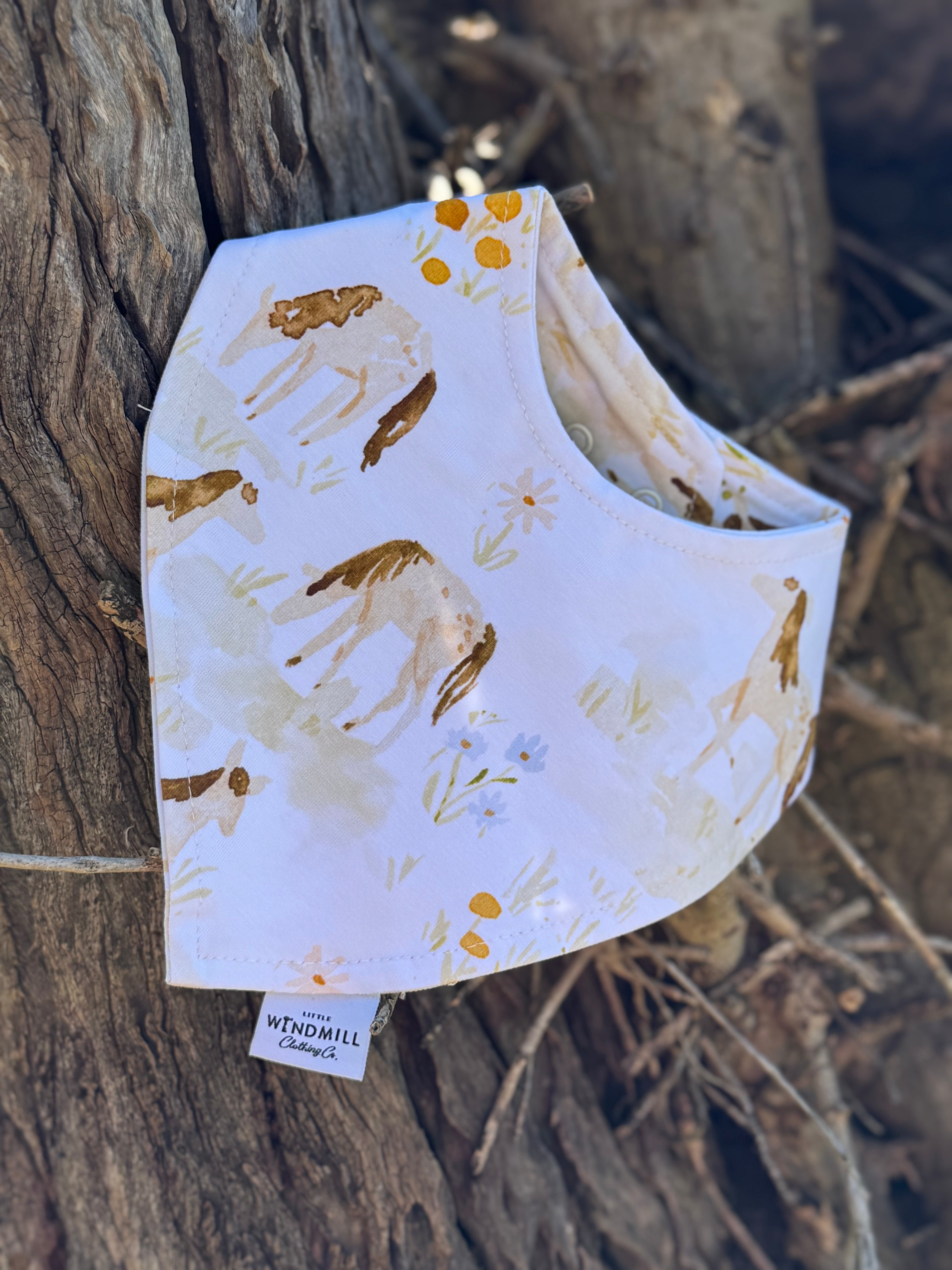 Waterproof horse field bib front view showing beautiful horse field scene print on wipeable waterproof fabric