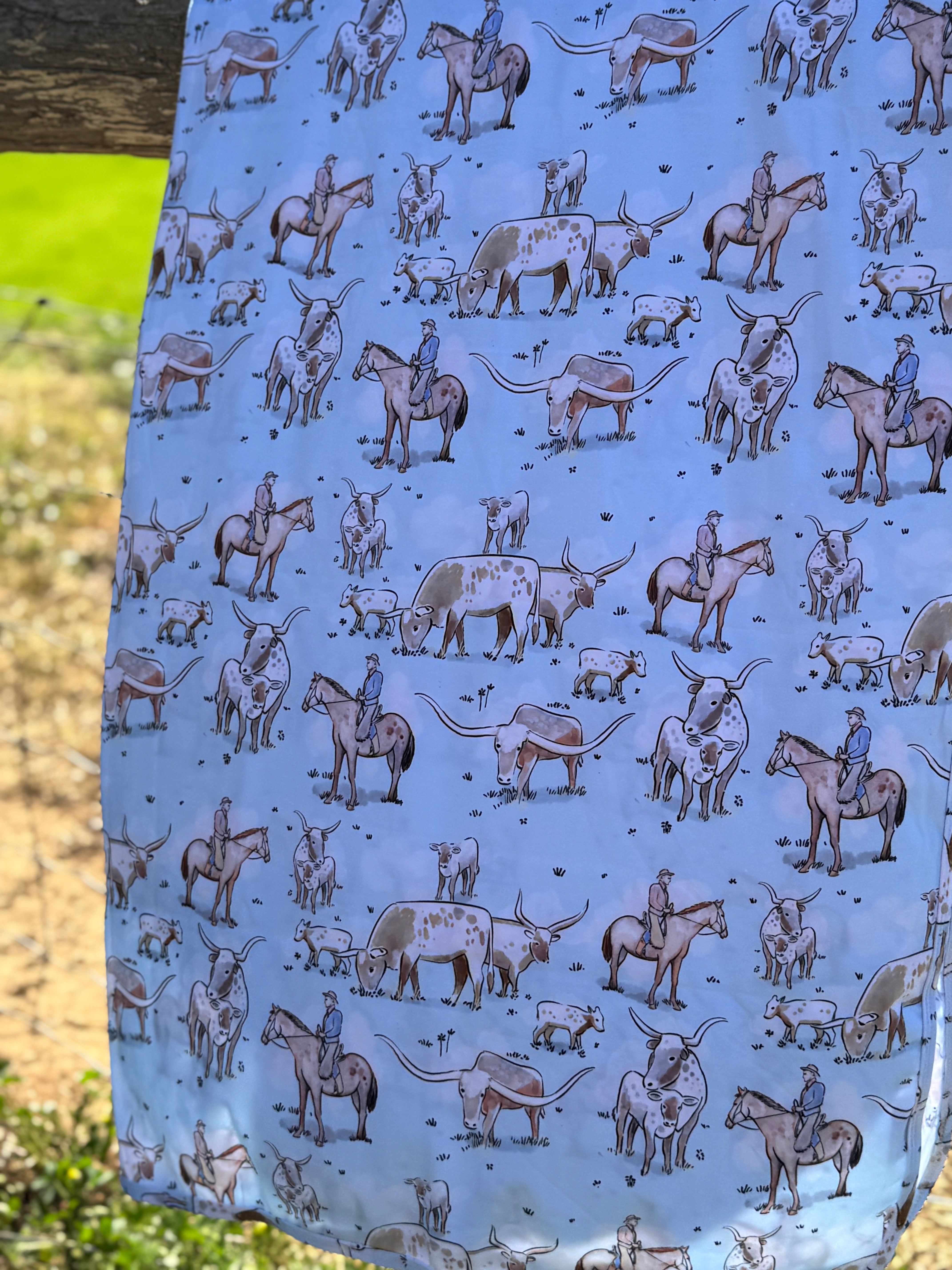 Blue long horn organic cotton swaddle open flat lay showing full size and longhorn pattern