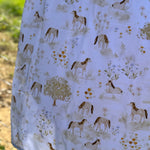 Horse field swaddle print close-up showing detailed horse field scene on soft organic jersey cotton