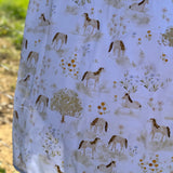 Horse field swaddle print close-up showing detailed horse field scene on soft organic jersey cotton