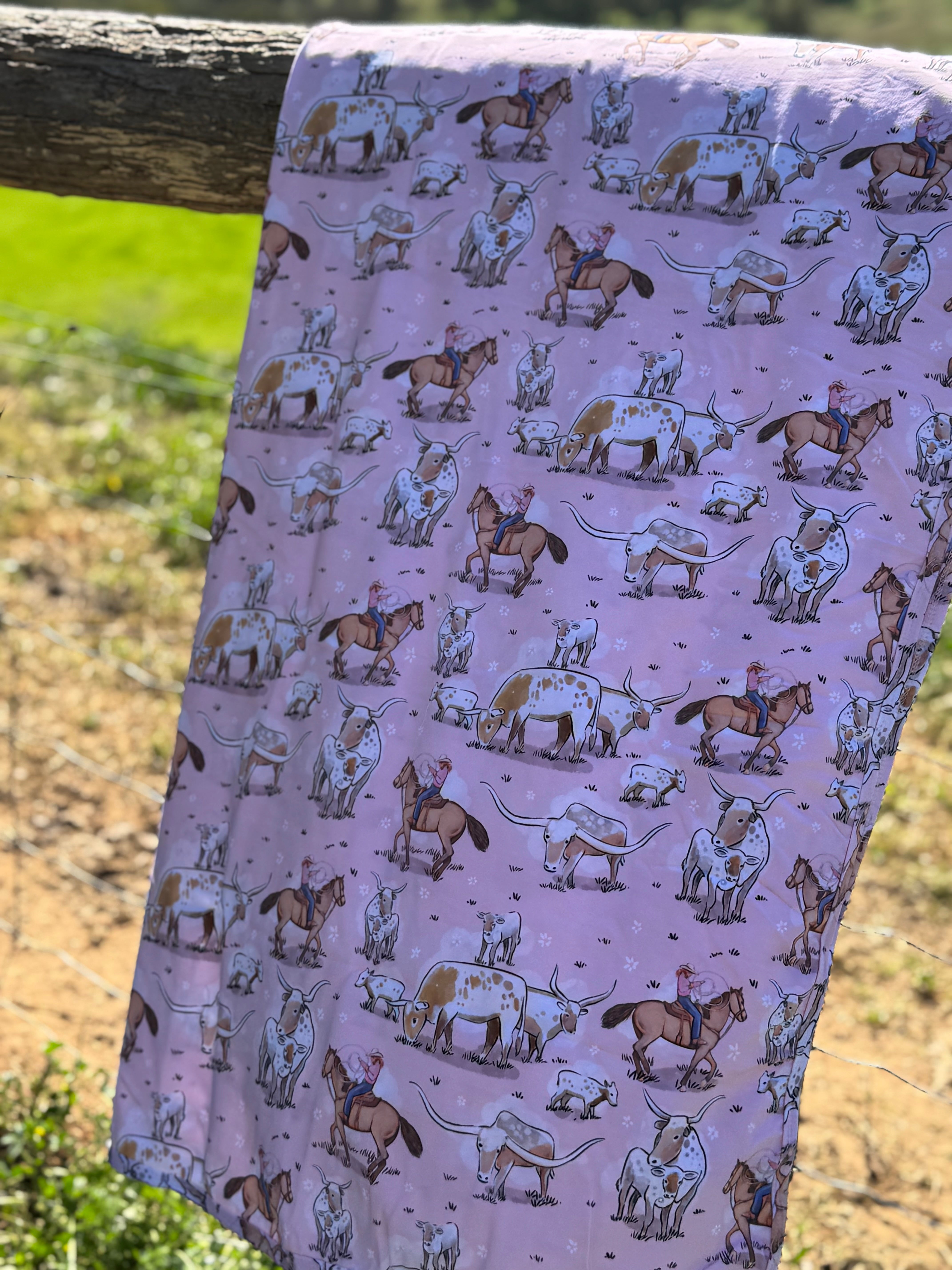 Pink long horn swaddle in use showing cosy newborn wrapped in organic cotton