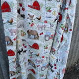 Farm yard organic muslin swaddle open flat lay showing full size and farm yard print pattern