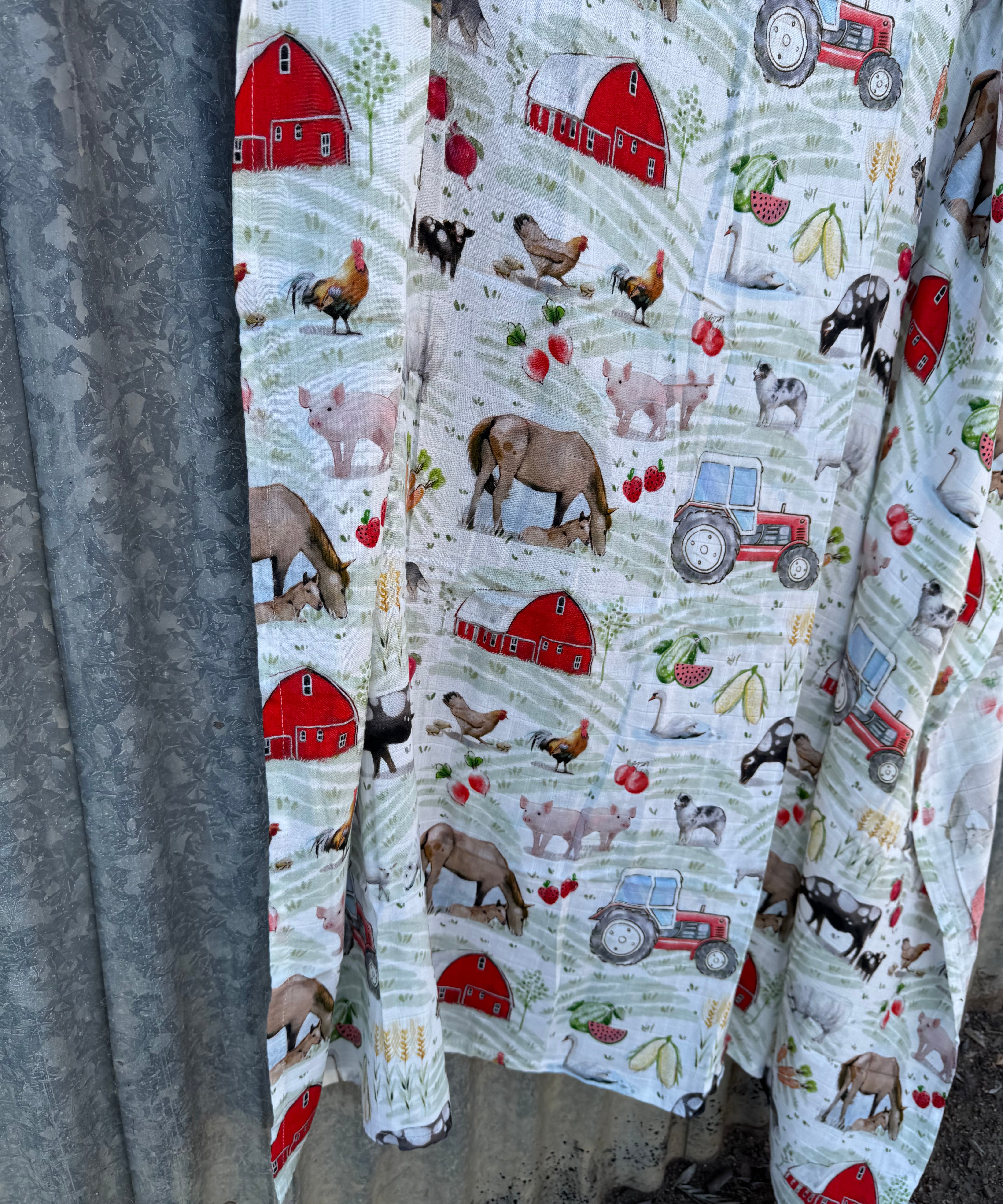 Organic light cotton muslin farm yard swaddle showing charming farm yard scene on breathable organic muslin