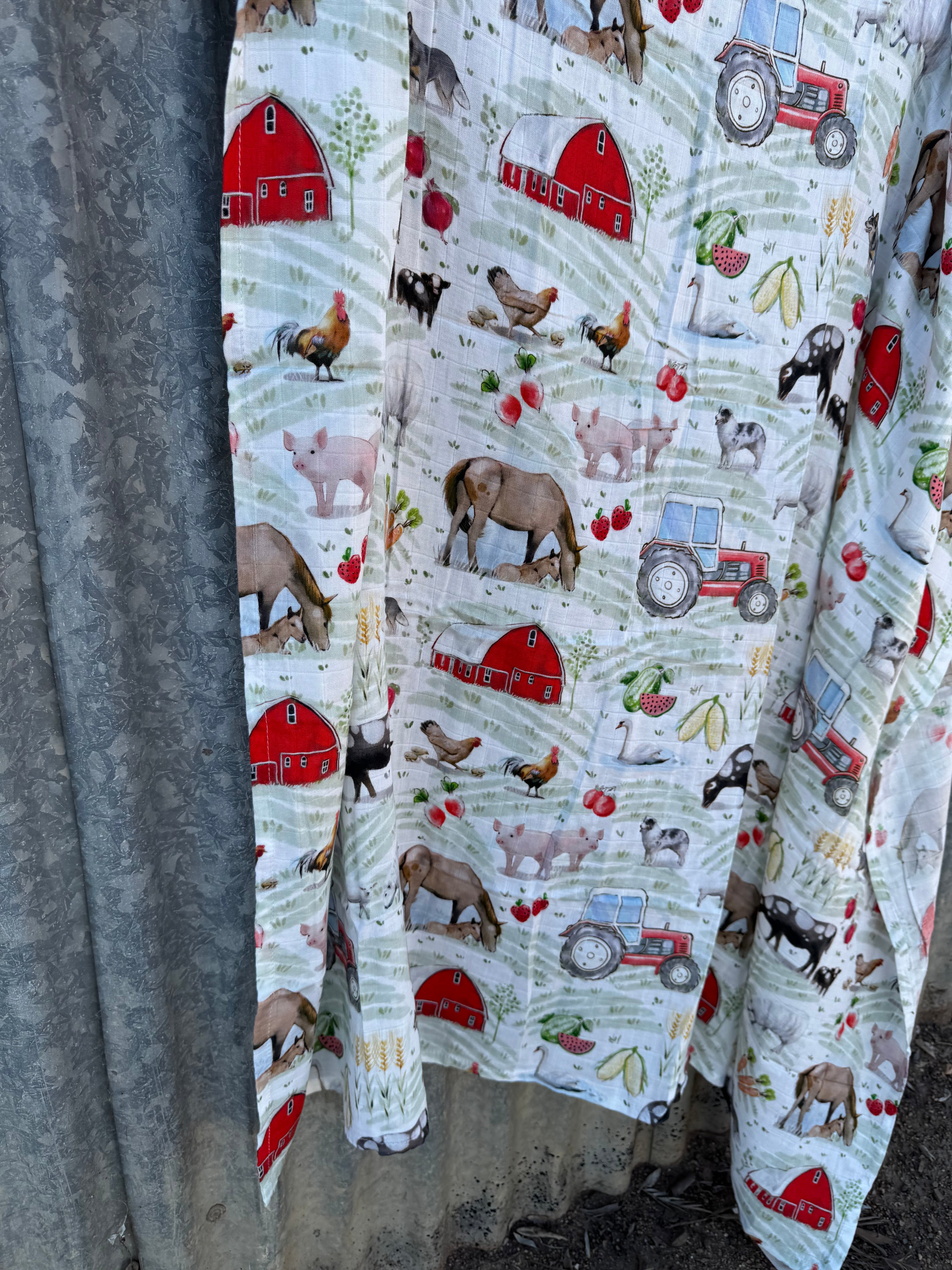 Organic light cotton muslin farm yard swaddle showing charming farm yard scene on breathable organic muslin