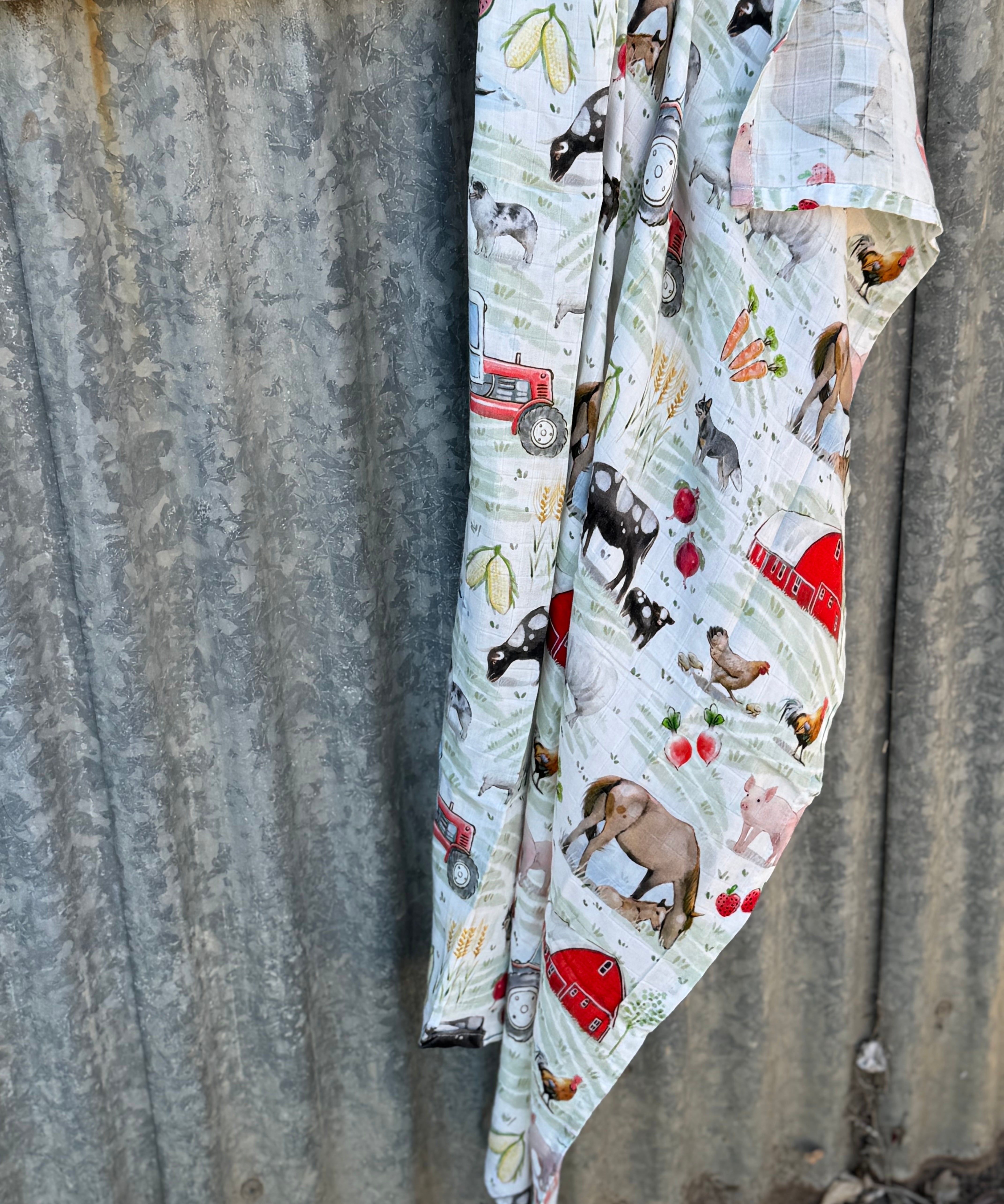 Farm yard organic muslin swaddle draped showing lightweight breathable swaddle for newborns