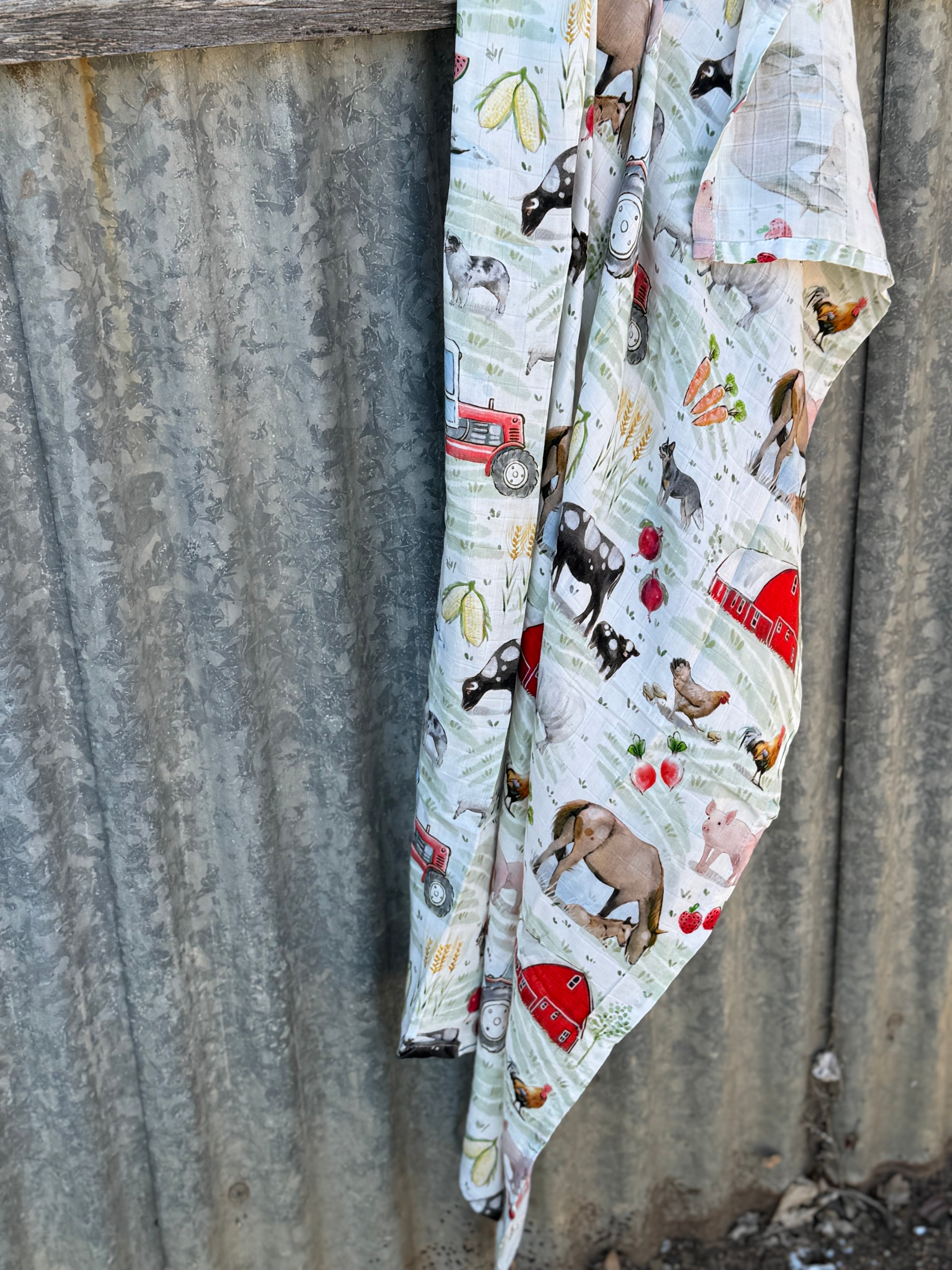 Farm yard organic muslin swaddle draped showing lightweight breathable swaddle for newborns