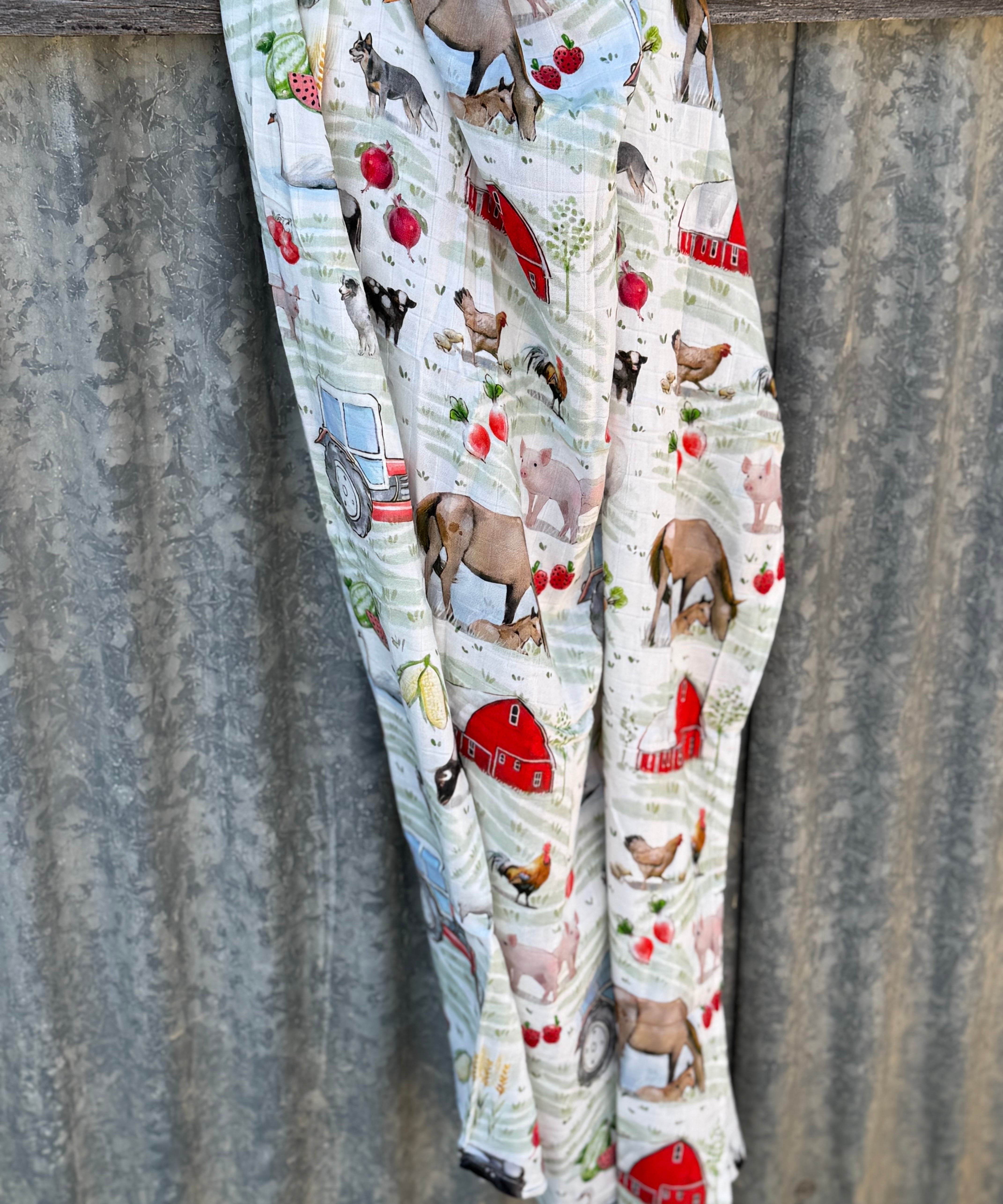 Farm yard muslin swaddle print close-up showing farm animal scenes on fine organic cotton muslin