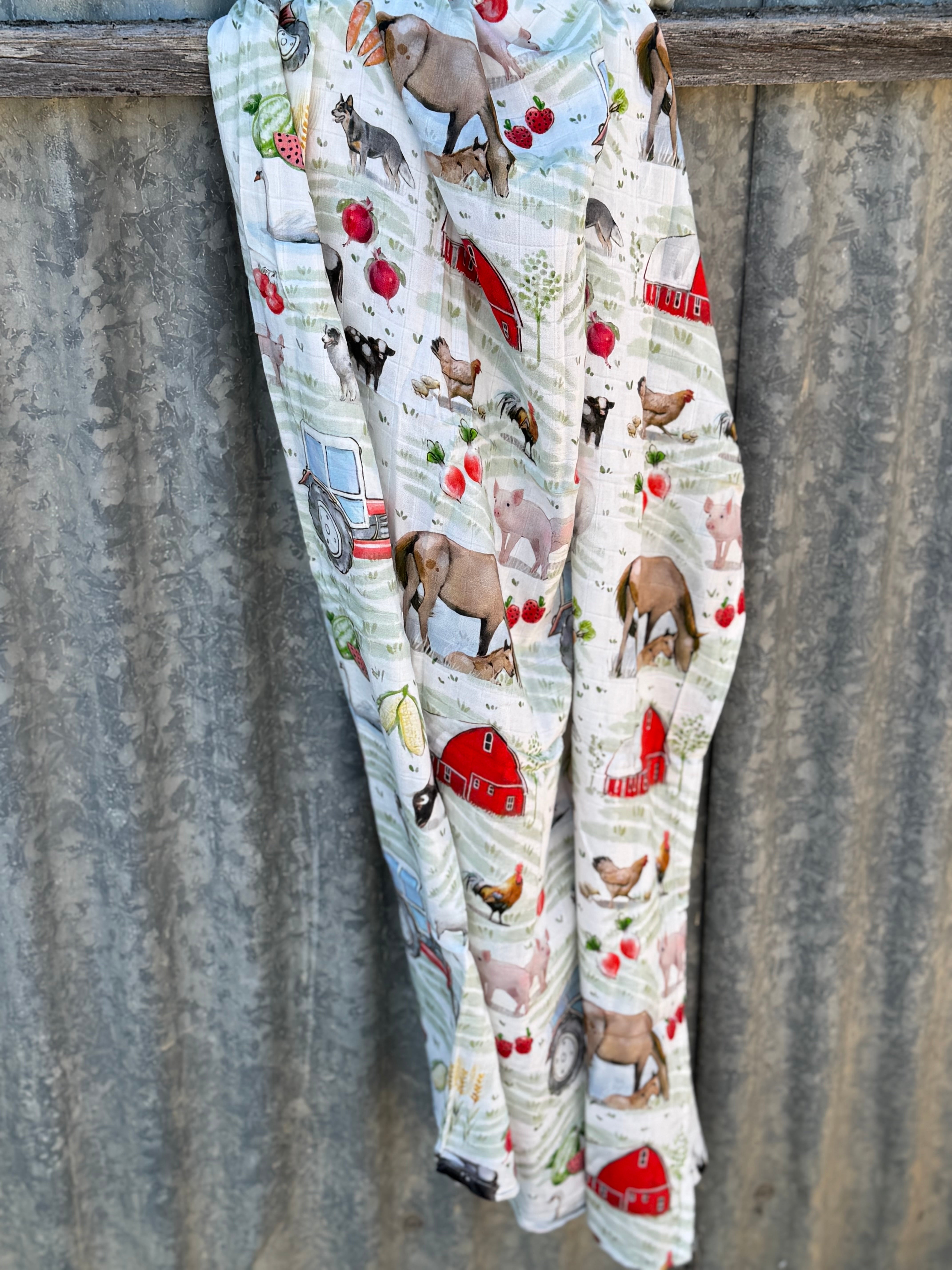 Farm yard muslin swaddle print close-up showing farm animal scenes on fine organic cotton muslin