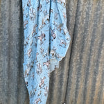 Blue longhorn organic muslin swaddle draped showing lightweight breathable swaddle for warmer weather