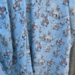 Blue longhorn muslin swaddle print close-up showing longhorn motifs on fine organic cotton muslin
