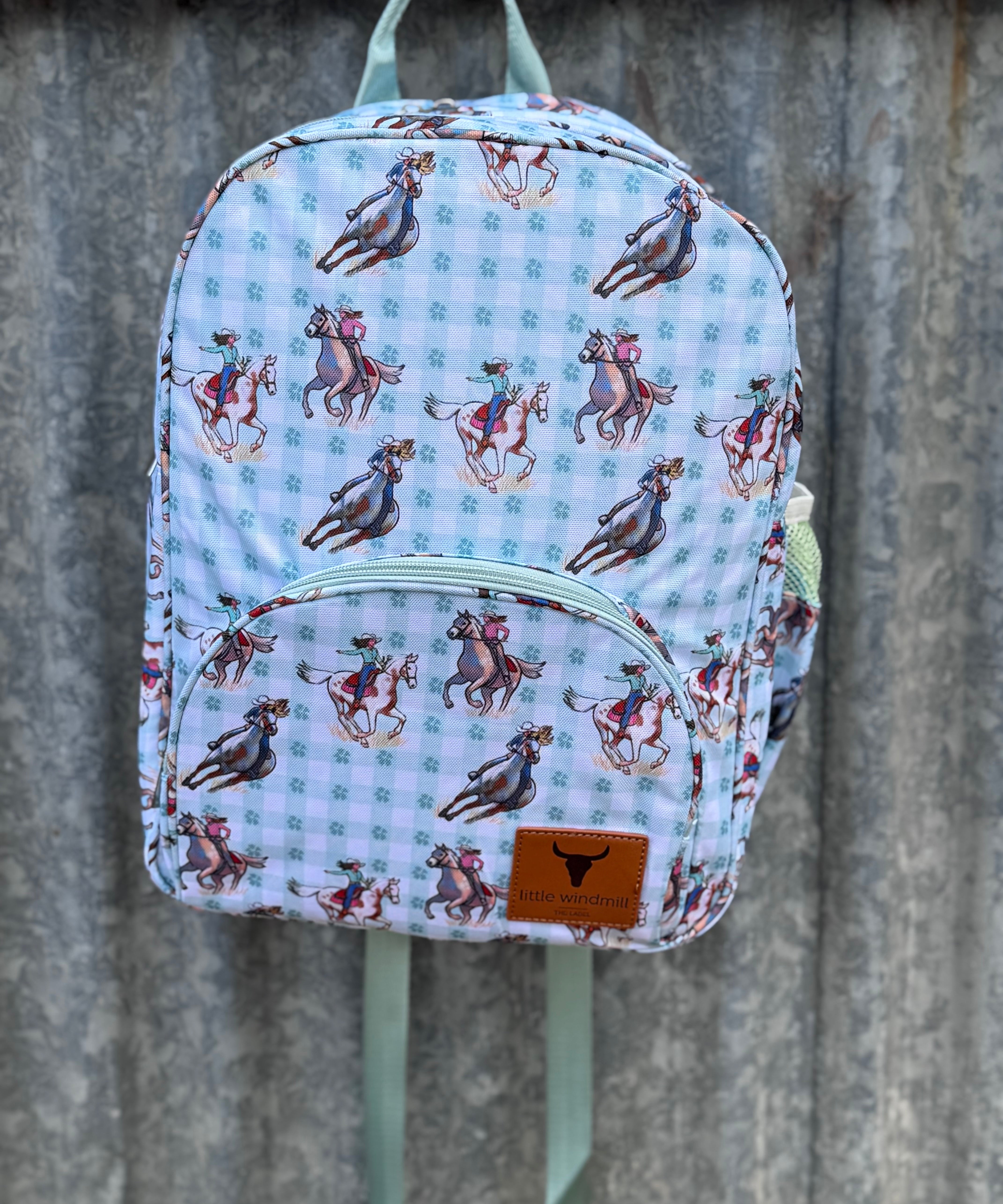Teal cowgirl backpack front view showing vibrant teal cowgirl print on quality kids school bag