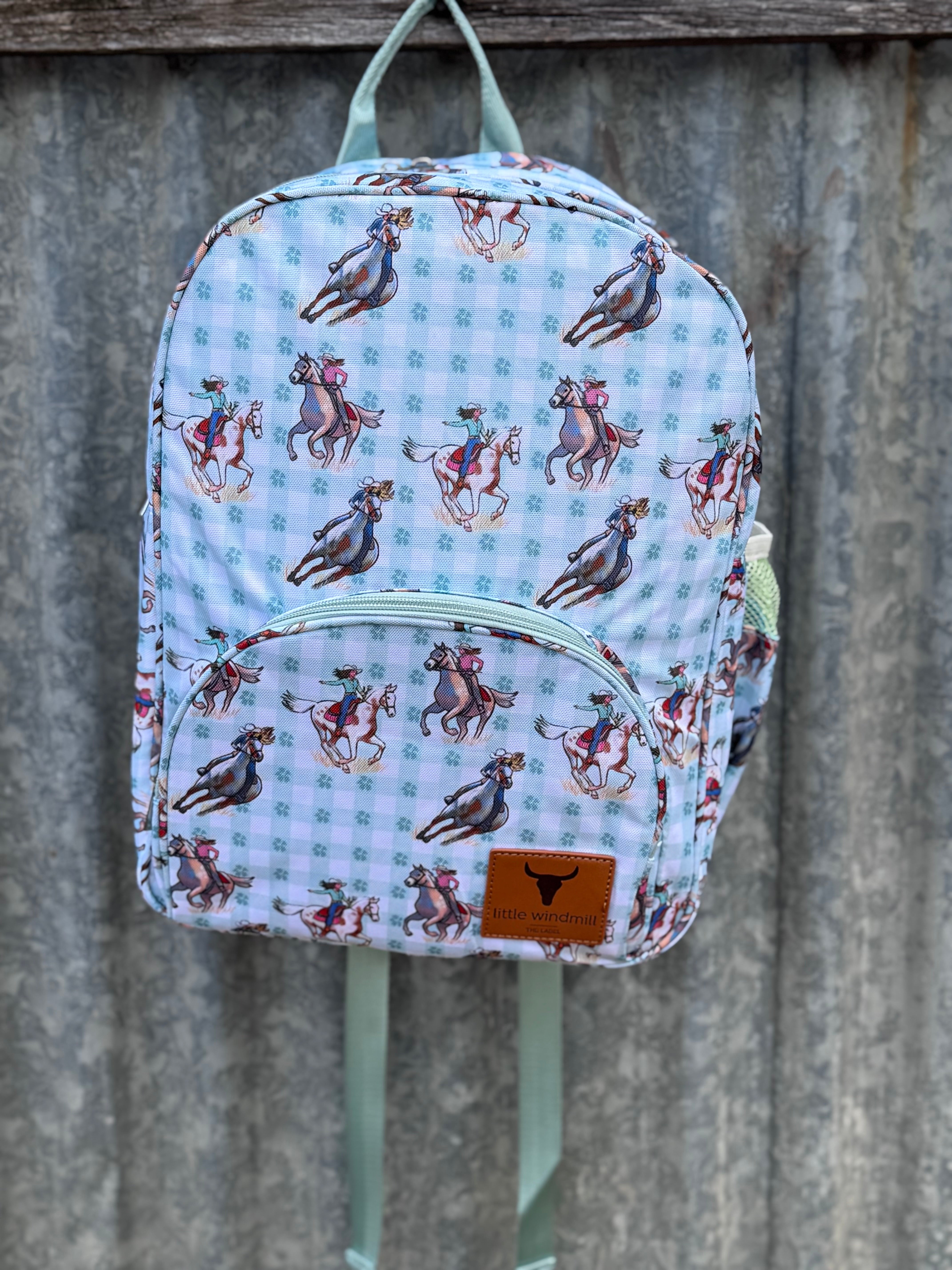 Teal cowgirl backpack front view showing vibrant teal cowgirl print on quality kids school bag