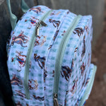 Teal cowgirl backpack flatlay showing full teal cowgirl western print school bag design