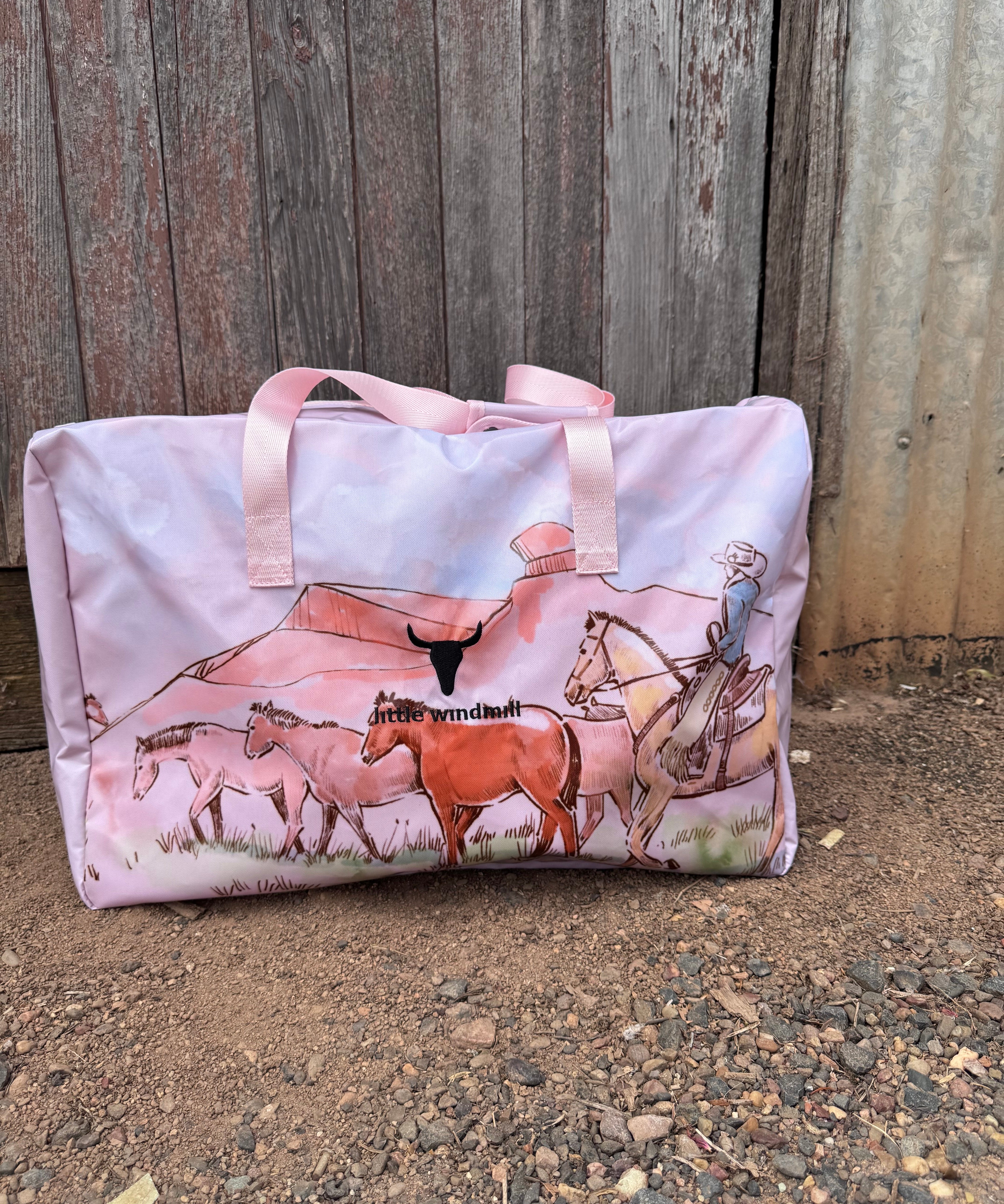 Pastel pink droving duffle bag front view showing sweet pastel pink western droving print travel bag