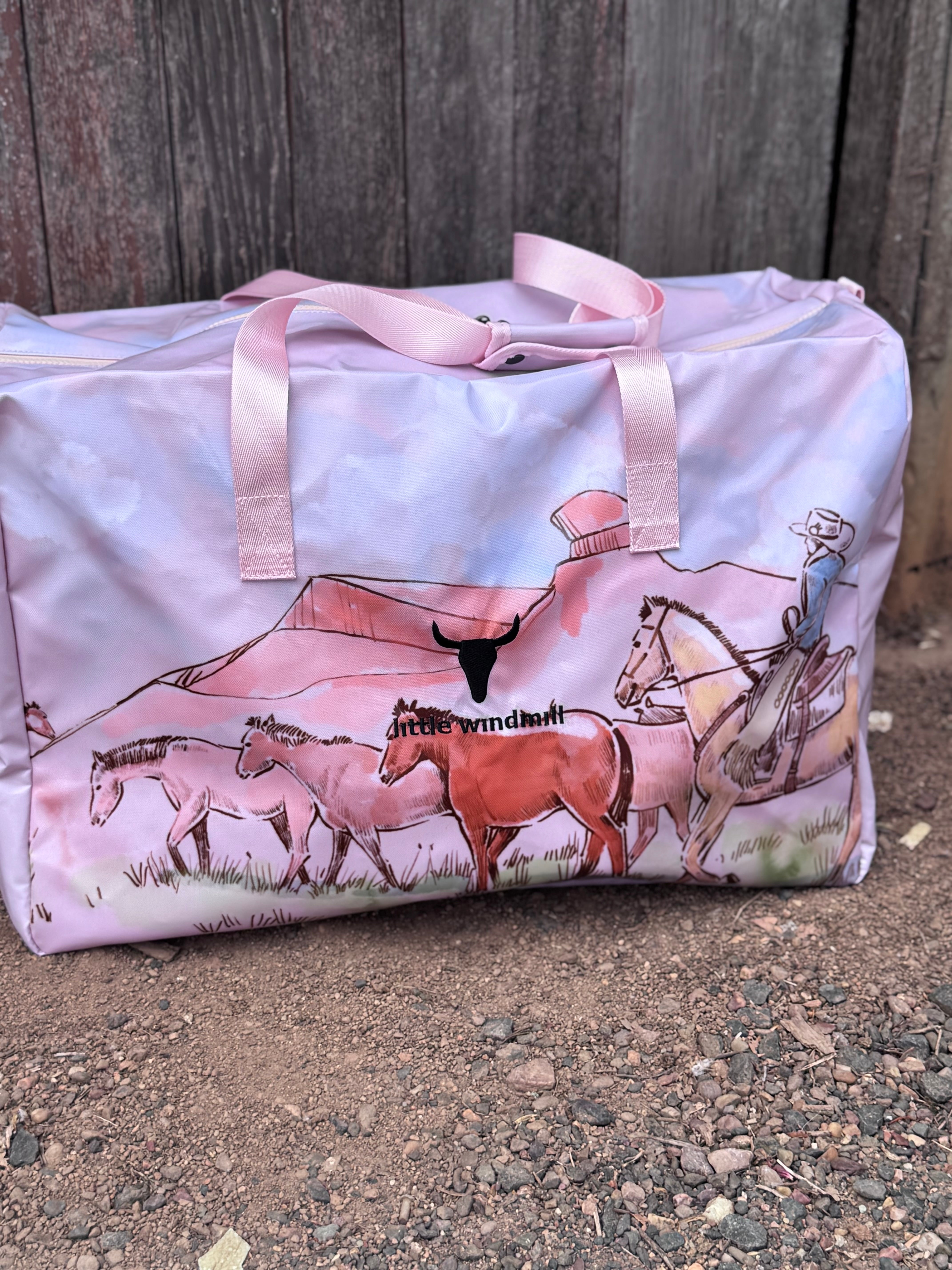 Pastel pink droving duffle bag strap and handle detail showing quality construction