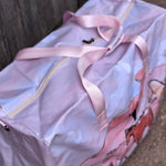 Pastel pink droving duffle bag print close-up showing detailed droving cattle print in pastel pink